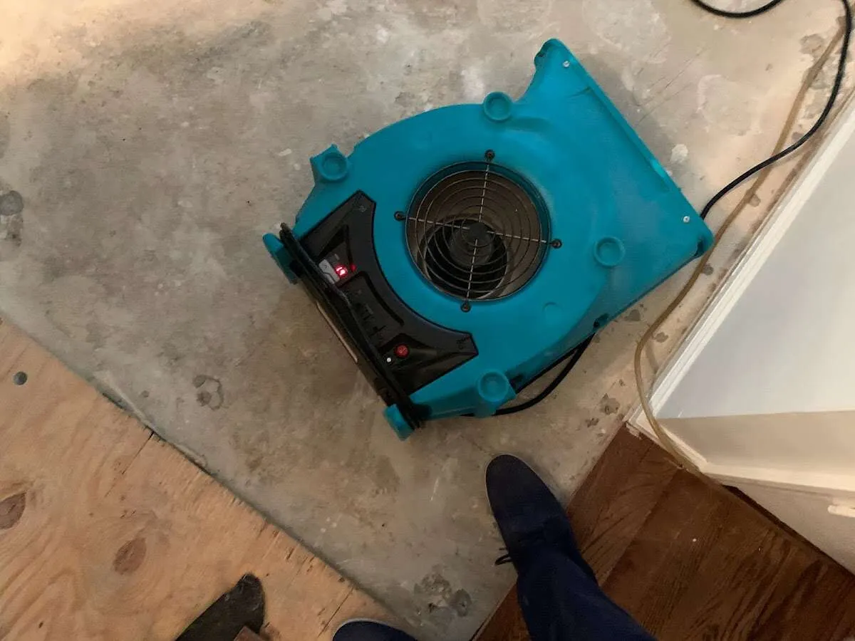 Air mover drying subfloor during Commercial Water Damage Restoration in River Park